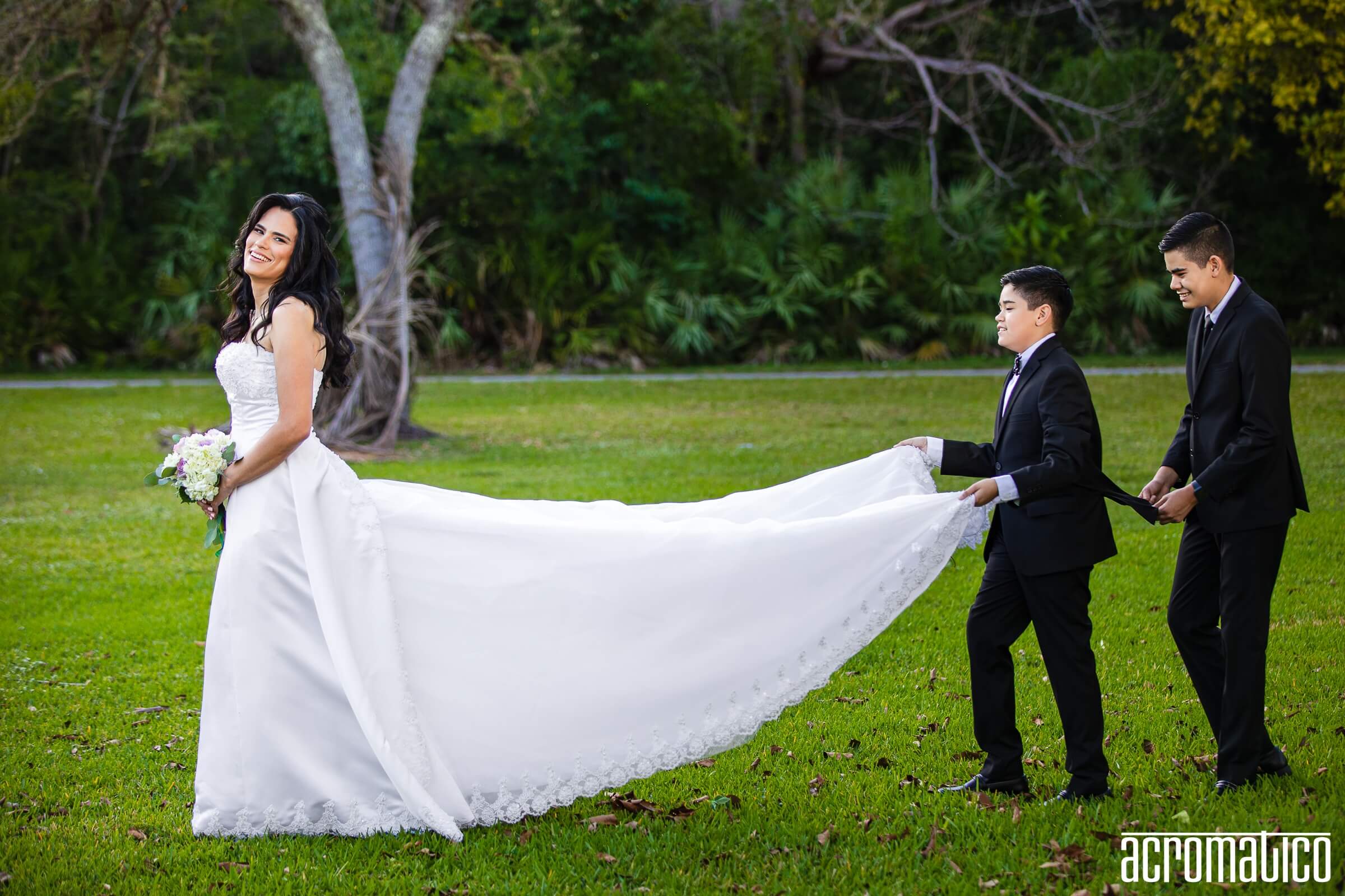 Documentary wedding photography - family helping with wedding dress train