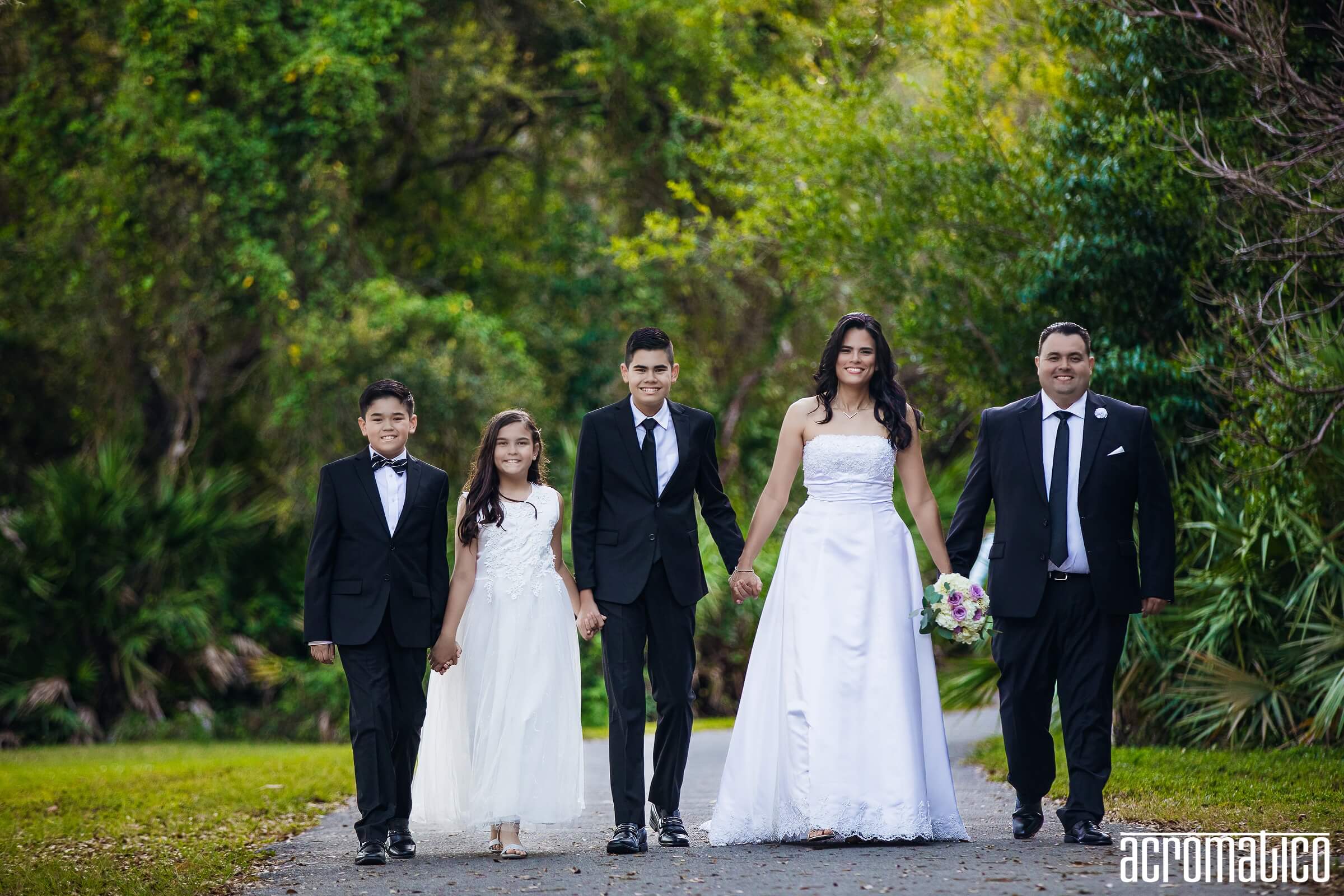 Family walking hand-in-hand through Matheson Hammock Park Miami
