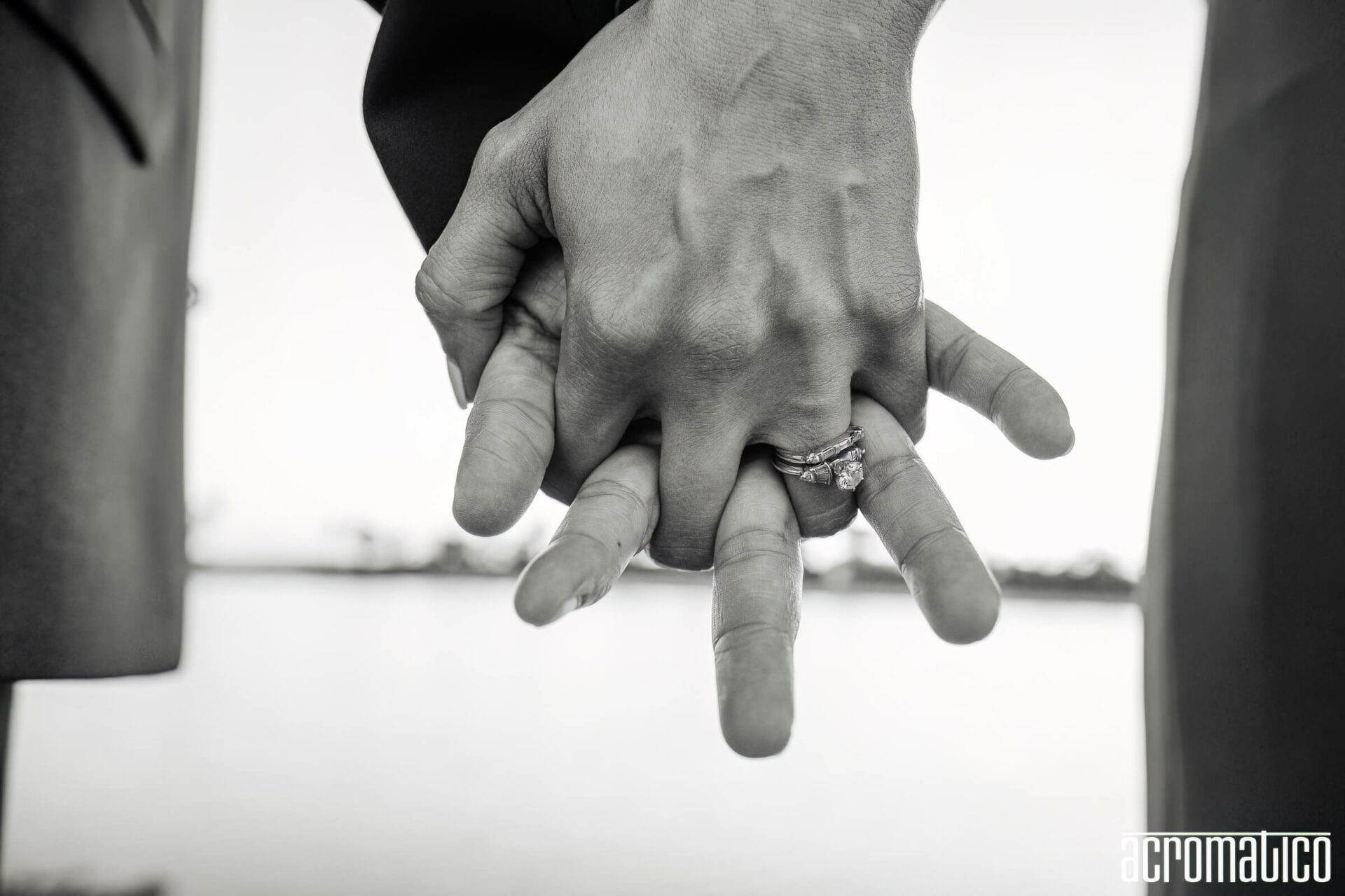 Close-up of couple holding hands showing wedding ring - 20th anniversary